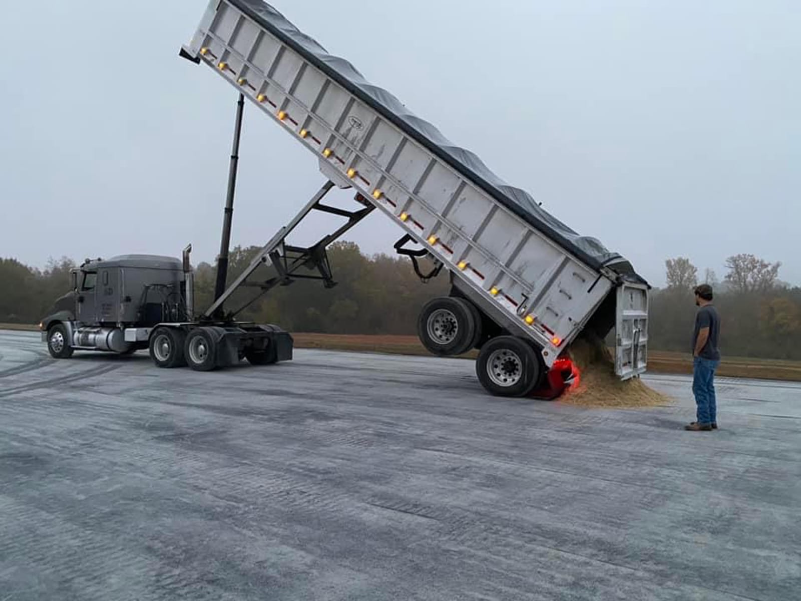 Large truck with dump bed, dumping sand